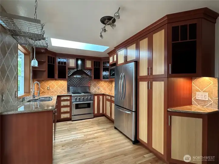 Main House kitchen with custom cabinets, high end appliances and a skylight.