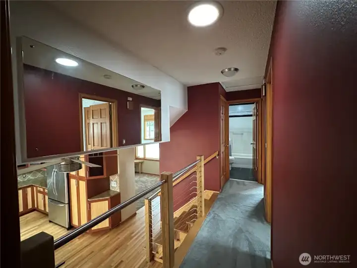 Upper Level Hallway looking toward the Main Full Bath and view to the Kitchen.Note the Solatube that reflects natural light year round.