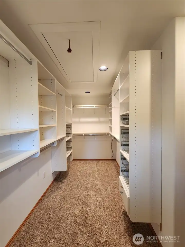 ADU Walk-In Closet with pull down stairs for attic storage.