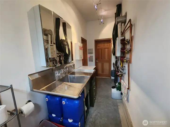 Shop Bathroom view toward the two separate entrances to each; large shop and smaller shop.