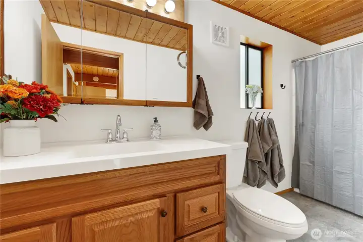 Full bath next to bedroom and laundry room
