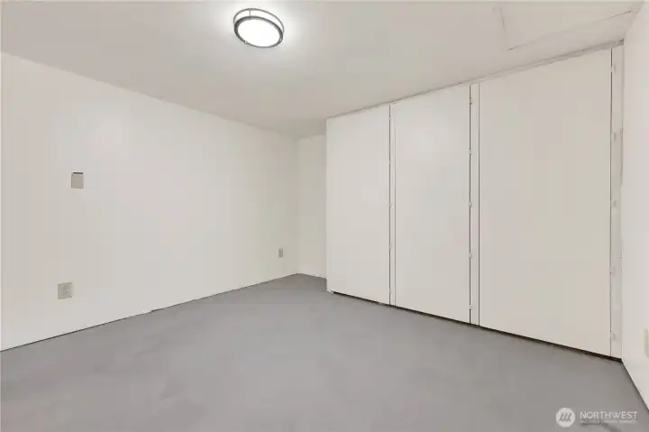 Storage room with access to plumbing in bathroom above