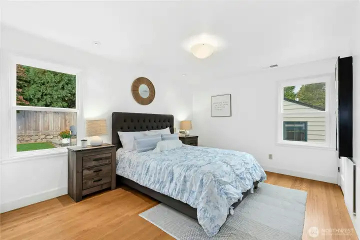 Main floor primary bedroom has views of beautiful backyard