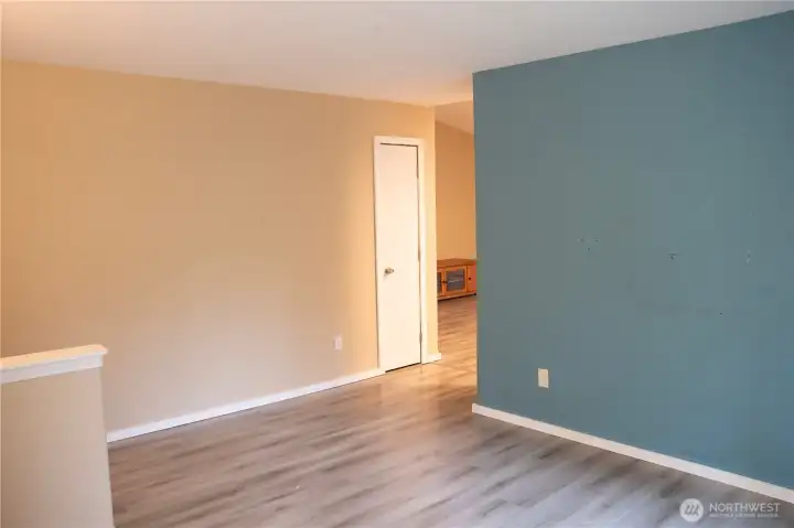 Standing in the open door, inviting you into a living room filled with warmth and comfort.