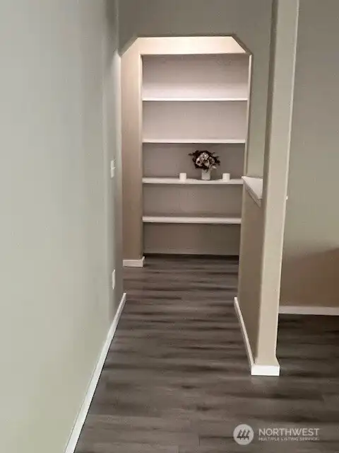 The hallway flows seamlessly into the bedroom, creating a welcoming path that invites relaxation.