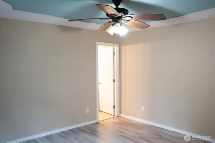 Spacious and stunning primary bedroom features a walk-in closet, perfect for relaxing and unwinding in style.