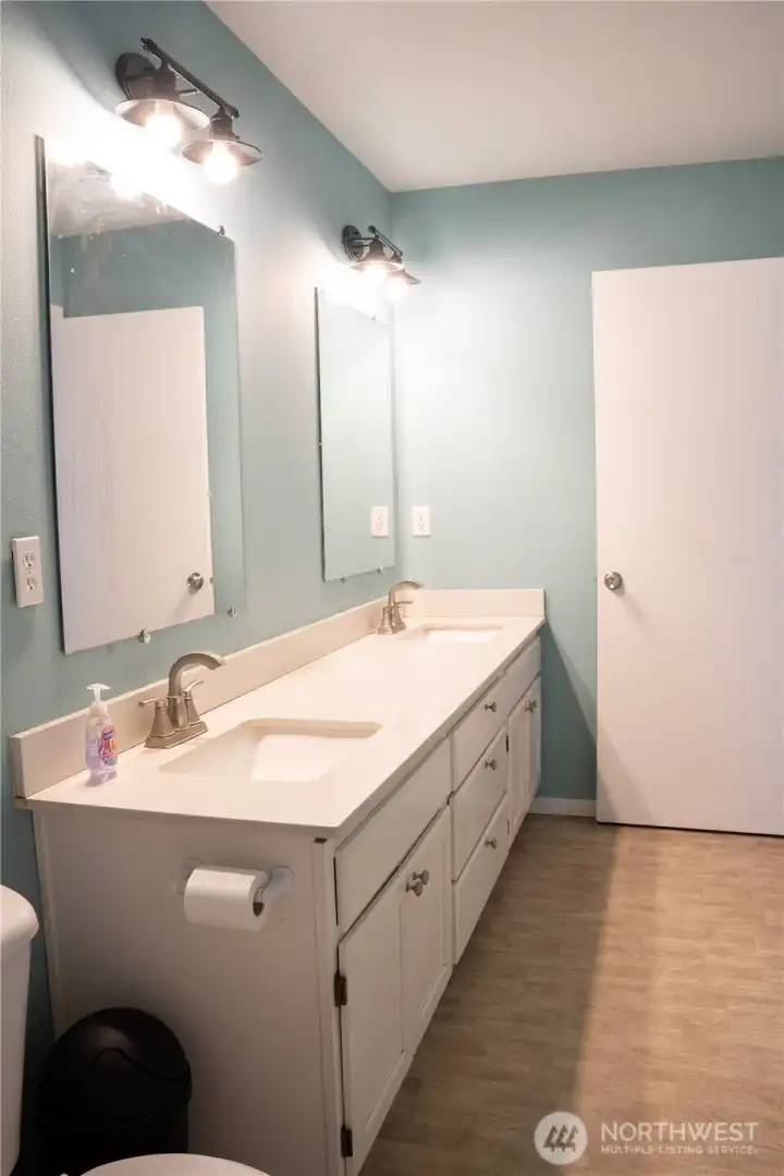 Enjoy the comfort of a spacious primary bathroom with dual sinks.