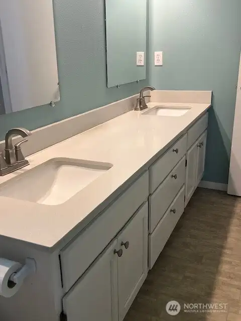 Enjoy the comfort of a spacious primary bathroom with dual sinks.