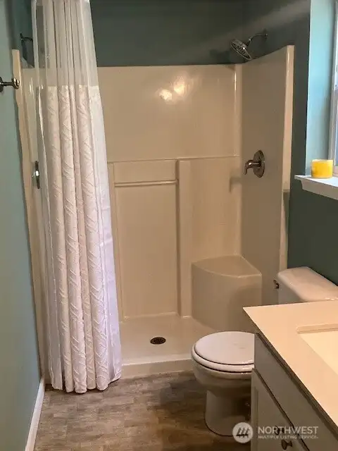 A chic contemporary bathroom awaits, complete with state of the art shower stall for a refreshing experience and a conveniently located toilet designed for every day comfort.