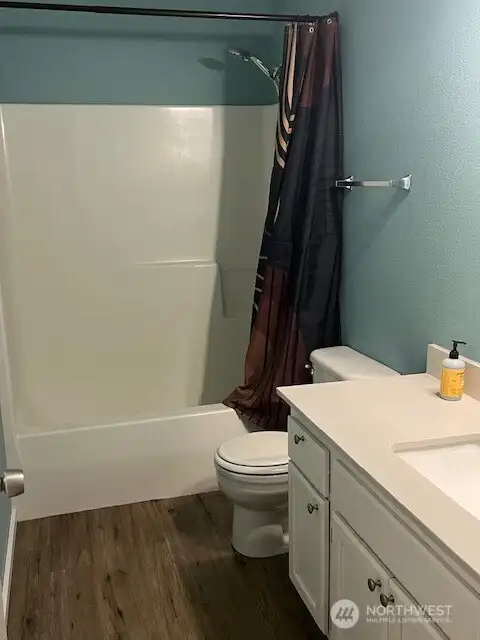 This hallway bathroom is a fully equipped, convenient space perfect for quick refreshment or guest use.