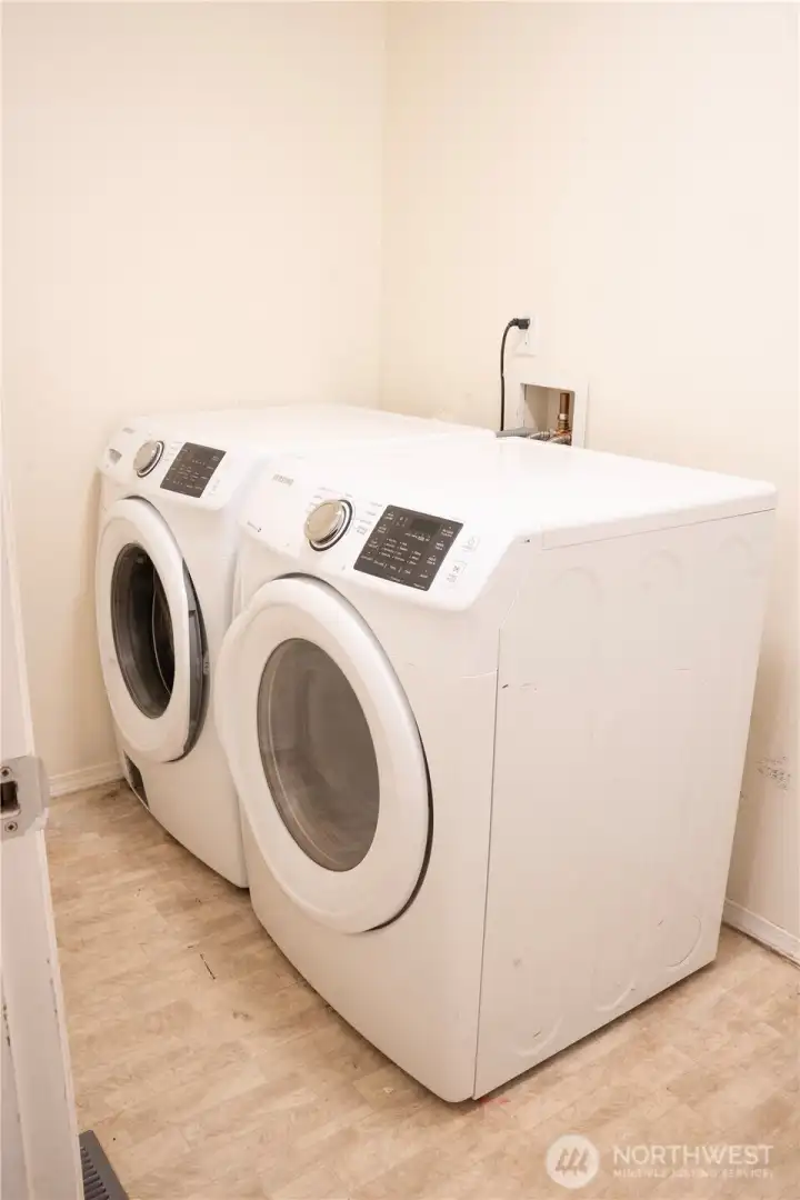 A spacious room at the end of the hallway, perfect for your needs. Plus, the washer and dryer stays with the home, offering added convenience.