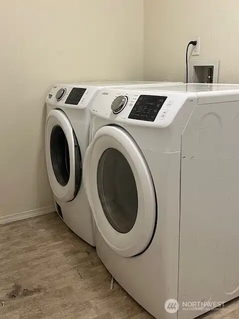 A spacious room at the end of the hallway, perfect for your needs. Plus, the washer and dryer stays with the home, offering added convenience.