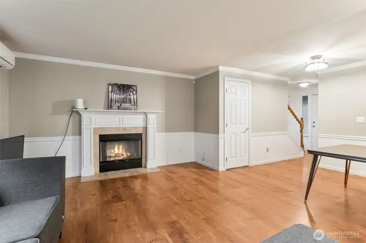Living Room with wood fireplace & Dining Area off Kitchen