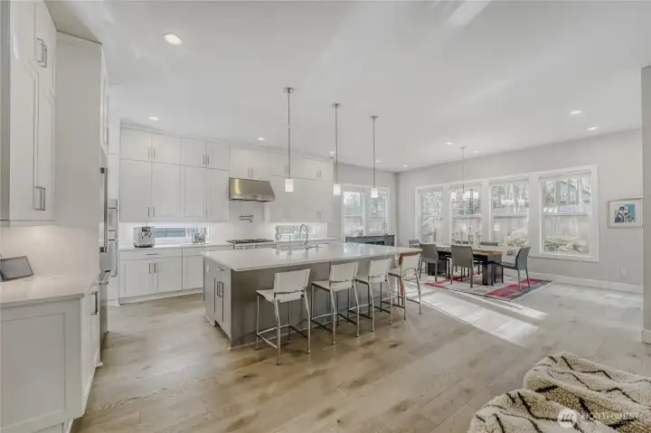 Sunlight pours through oversized windows, highlighting the home’s airy living spaces.