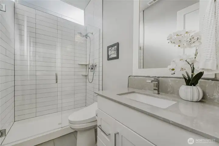 A modern, yet understated guest 3/4 bathroom on the main floor.