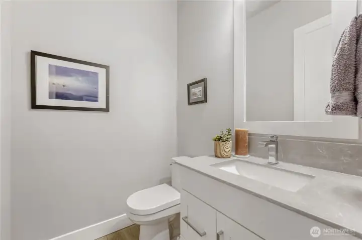 The main level powder room is understated and inviting.