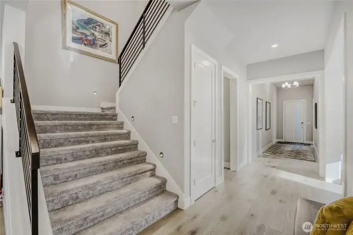 A stately, broad stairwell ushers you upstairs.