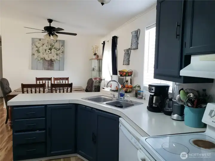 Open Spacious Bright Kitchen with Ample Amount of Real Wood Cabinets, Counter Tops, All Appliances Stay, Newer Laminate Flooring,