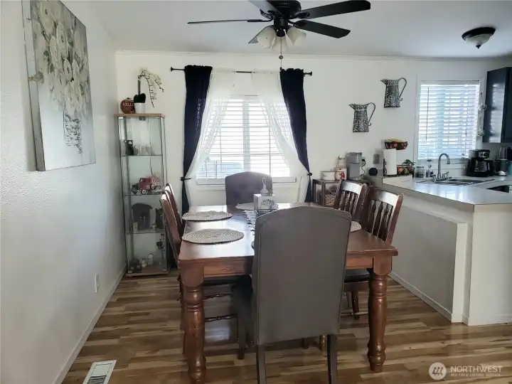 The Formal Dining Room with Cathedral Ceiling, Newer Laminate Flooring Looking into the Dining Room.