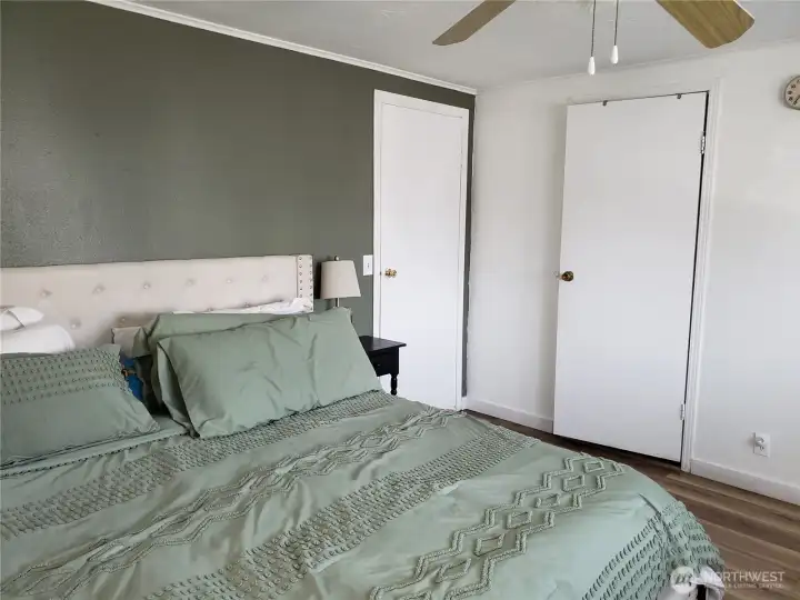 A Different View of the Spacious Primary Master Bedroom with Newer Paint, Trim and Vinyl Plank Flooring Looking at the the Huge Primary Walk In Closet.
