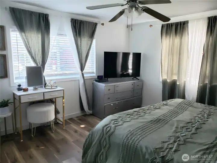 Another View of the Spacious Primary Master Bedroom with Newer Paint, Trim and Vinyl Plank Flooring from the Primary Bath Room.