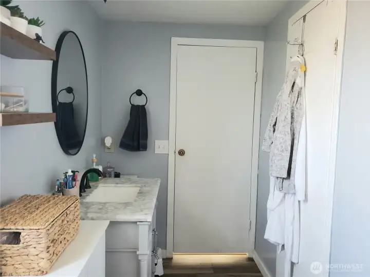 Another View of the Large Primary Master Bath Room with Newer Paint, Trim, Sink, Toilet, Faucet, Counter Top, and Vinyl Plank Flooring.