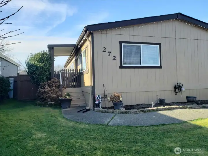 Another Picture Manicured Front and Side yard that lead to the Covered Porch and Front Entry Door.