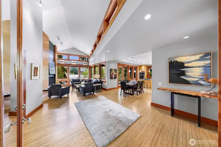 Soaring ceilings & clerestory windows expand the entry space and draw the eye forward toward the living room and shimmering water beyond.