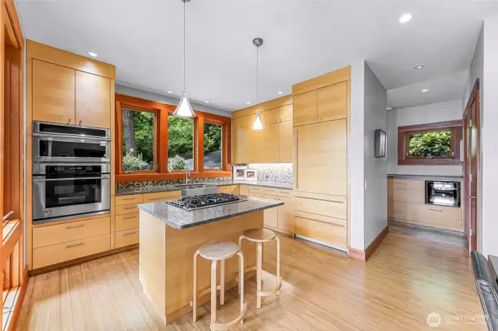 Laundry room + butler's kitchen adjacent to kitchen faciltates entertaining, with versatility. Beverage center, sink + counter space adds convenient & discreet workspace or a desiganted wet bar.