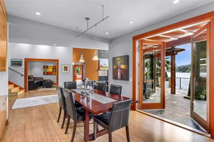 Large double doors lead to main level south-facing deck: effortless indoor-outdoor living, drenched in sunlight.