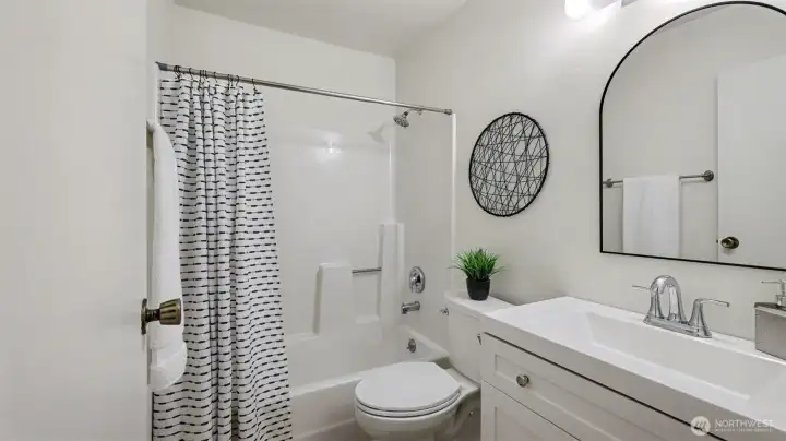 Updated bathroom with new vanity and toilet is bright and spacious.