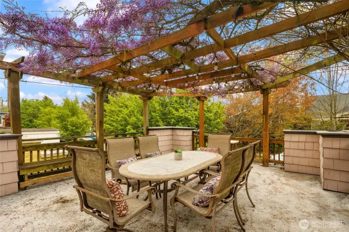 This large patio is elevated over the street, making it private with gorgeous wisteria!