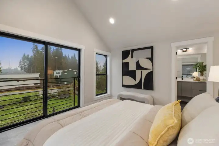 Primary bedroom with large windows offering abundant natural light.