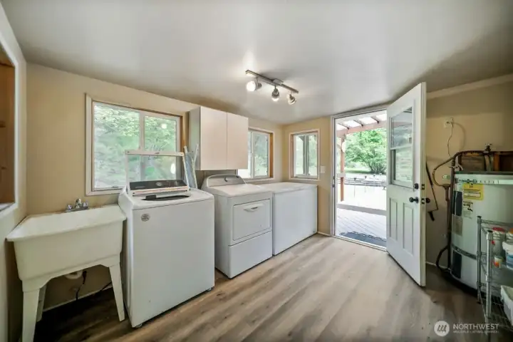 utility room with door to back deck