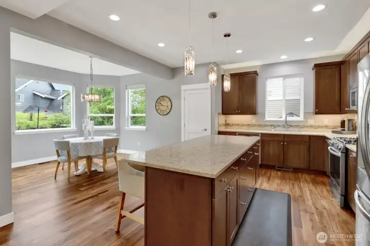 Kitchen with granite countertops, large island, and walk-in pantry