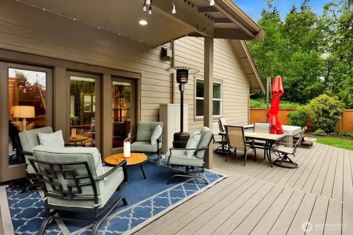 Deck entertaining area with trellis, hot tub, and gathering space