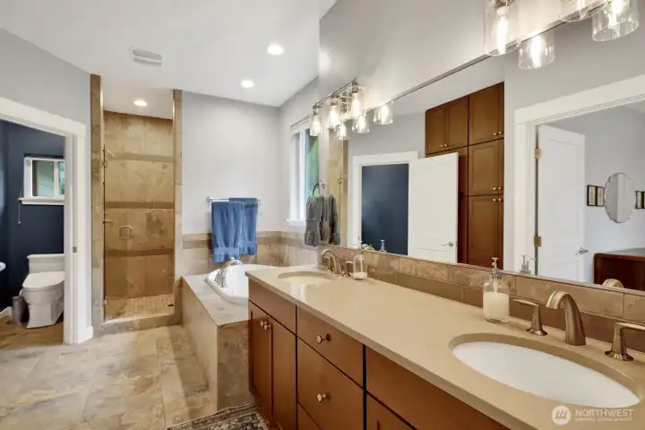 Primary bathroom with walk-in shower and dual vanity