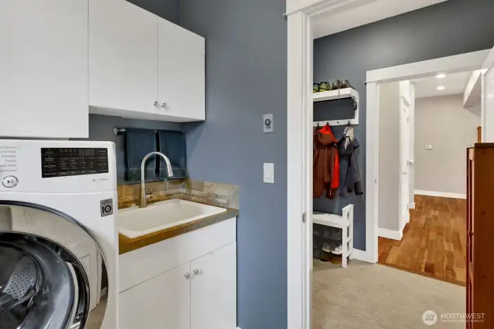 Laundry room with storage and utility sink