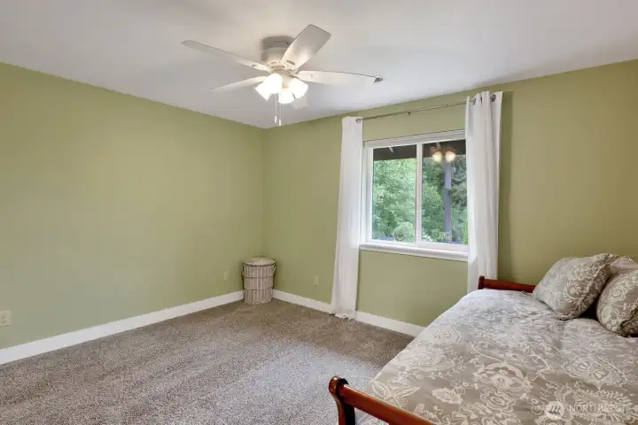 Additional upper level bedroom with backyard views
