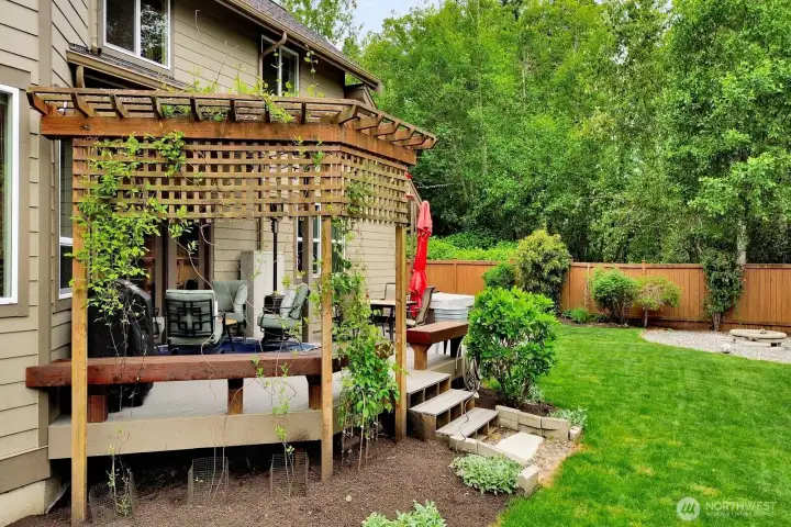 Rear exterior showing yard and outdoor living flow