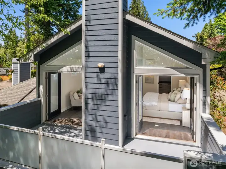 A set of French doors opens to a private deck with serene wooded views.