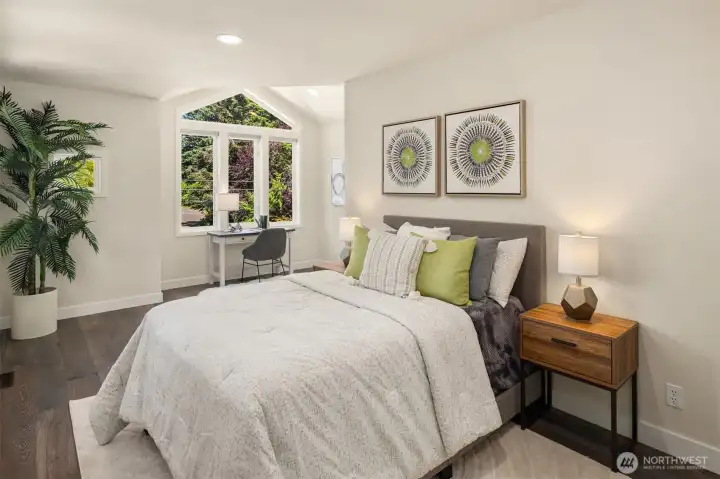 A large 2nd bedroom features additional space for a desk, play room space, or exercise equipment.