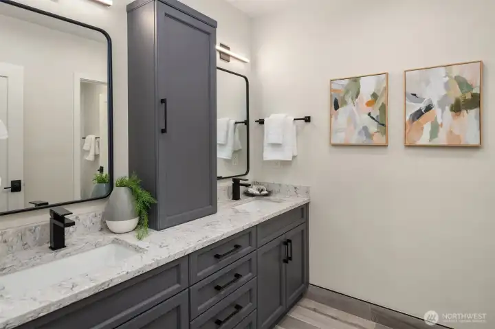 The second bathroom upstairs is updated and features double sinks and lots of storage.