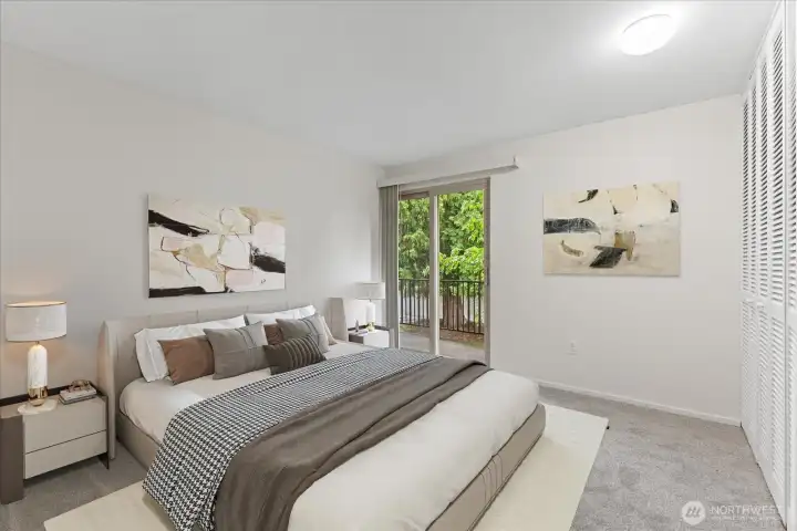 Virtually staged master bedroom featuring a large closet and sliders leading to the balcony, providing a peaceful area to relax.