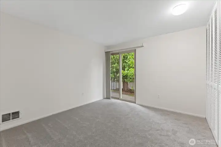 Master bedroom featuring a large closet and sliders leading to the balcony, providing a peaceful area to relax.