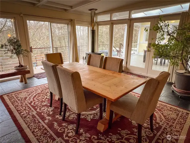 The living room has another free standing stove, hide-away TV, dining area, deck access...and a Murphy Bed.