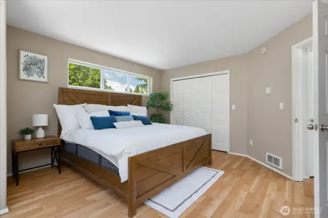 To the right of the bed is the walk in closet in the Primary Suite.