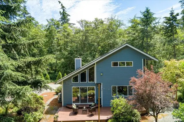 Looking down at the deck off the living room. To the right is an area to have bonfires.