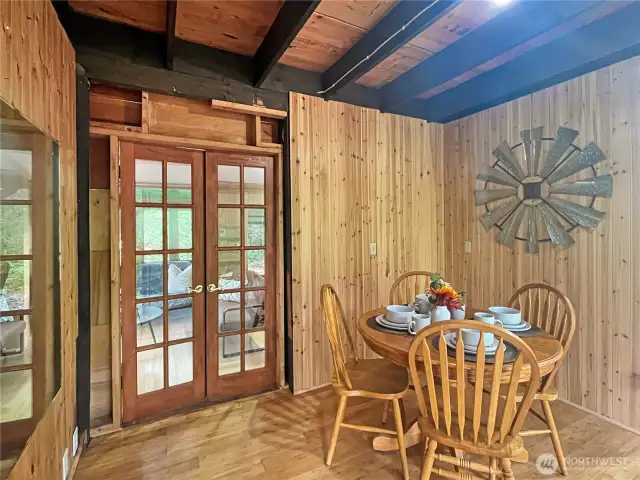 Cute dining area opens to living space through French doors and has slider to outaide