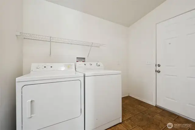 Laundry/mudroom that leads to the fully chain linked back yard, with 2 gates.